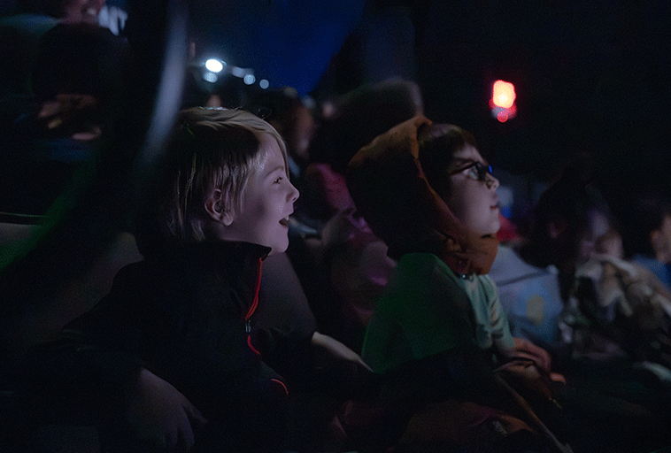 Two elementary students watching the stage during a show.